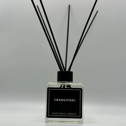 oil for reed reed diffuser bottle with a white label reading "FRANGIPANI" - WHITE MAGIC CANDLES."