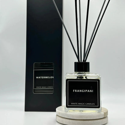 Square glass reed diffuser bottle with a black label reading "FRANGIPANI" - WMC